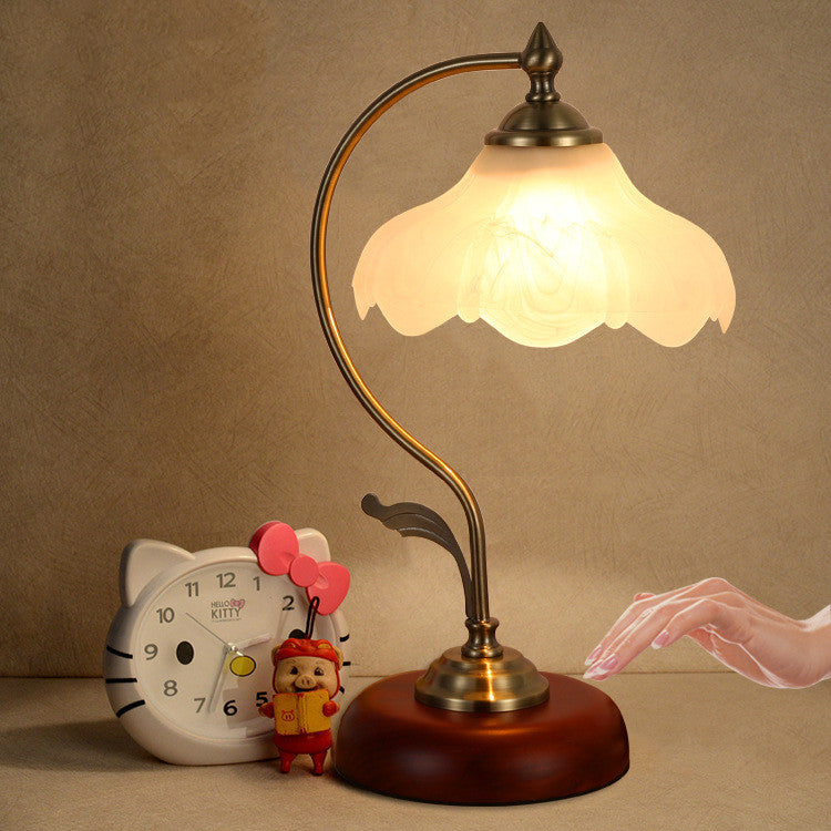 Lotus glass touch sensor table lamp on a bedside surface